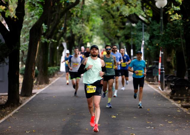 (251013) -- BUCHAREST, Oct. 13, 2025 (Xinhua) -- Participants run in Cismigiu park during the Bucharest Marathon in Bucharest, Romania, Oct. 12, 2025. (Photo by Cristian Cristel/Xinhua)