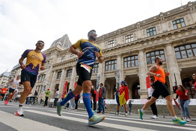 (251013) -- BUCHAREST, Oct. 13, 2025 (Xinhua) -- Participants run past the National History Museum during the Bucharest Marathon in Bucharest, Romania, Oct. 12, 2025. (Photo by Cristian Cristel/Xinhua)