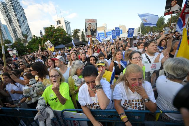 (251013) -- TEL AVIV, Oct. 13, 2025 (Xinhua) -- People watch live broadcasting of the release of hostages on a square in Tel Aviv, Israel, on Oct. 13, 2025. Hamas on Monday morning began releasing the first batch of hostages who had been held in Gaza for more than two years, as part of a major prisoner swap under a newly implemented ceasefire, Israel's state-owned Kan TV reported. (Photo by Jamal Awad/Xinhua)