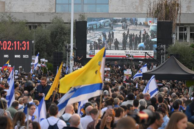 (251013) -- TEL AVIV, Oct. 13, 2025 (Xinhua) -- People watch live broadcasting of the release of hostages on a square in Tel Aviv, Israel, on Oct. 13, 2025. Hamas on Monday morning began releasing the first batch of hostages who had been held in Gaza for more than two years, as part of a major prisoner swap under a newly implemented ceasefire, Israel's state-owned Kan TV reported. (Photo by Jamal Awad/Xinhua)