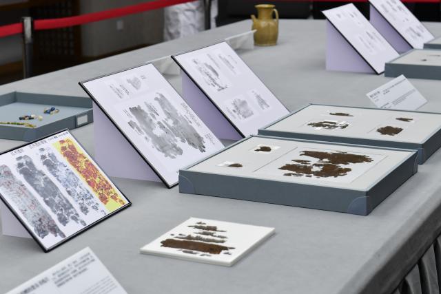 (251013) -- CHANGSHA, Oct. 13, 2025 (Xinhua) -- This photo taken on Oct. 13, 2025 shows part of the Zidanku Silk Manuscripts on display at the Hunan Museum in Changsha, capital of central China's Hunan Province.
  Two volumes of Chinese silk manuscripts dating back about 2,300 years have been returned to central China, 79 years after they were smuggled out of the country, through cooperation between Chinese and the U.S. cultural institutions.
  The second and third volumes of the Zidanku Silk Manuscripts -- precious cultural artifacts dating back to the Warring States Period (475-221 B.C.) -- were on Monday officially repatriated to Hunan Province. They will be permanently archived in the Hunan Museum in Changsha, the provincial capital.
  The manuscripts, which were unearthed from a Chu-state tomb by tomb raiders at the Zidanku site in Changsha in 1942, consist of three volumes: "Sishi Ling," "Wuxing Ling" and "Gongshou Zhan." They are a systematic record of astronomy, calendars, cosmology and military divination from China's pre-Qin period. The silk manuscripts are the earliest examples of silk text discovered to date and the oldest classical Chinese book in the true sense. They were smuggled out of China in 1946.
  At the accession ceremony of the Zidanku Silk Manuscripts (Volumes II and III) on Monday, National Cultural Heritage Administration (NCHA) head Rao Quan said that the return of the manuscripts is a significant achievement of years of Sino-U.S. cultural and museum cooperation, and an example for international cooperation on artifact restitution.
  Through Sino-U.S. cooperation on the return of cultural property, the "Wuxing Ling" and "Gongshou Zhan" volumes were returned to China by the Smithsonian Institution's National Museum of Asian Art this year, arriving in Beijing on May 18. (Xinhua/Chen Zhenhai)