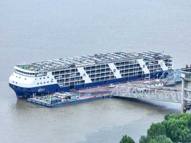 (251013) -- BEIJING, Oct. 13, 2025 (Xinhua) -- An aerial drone photo taken on Oct. 13, 2025 shows a ship loaded with cars setting sail from a port in Wuhan, central China's Hubei Province. China's total goods imports and exports in yuan-denominated terms rose to 33.61 trillion yuan (about 4.73 trillion U.S. dollars) in the first nine months of 2025, up 4 percent year on year, official data showed Monday. (Photo by Zhao Jun/Xinhua)