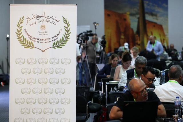 (251013) -- SHARM EL-SHEIKH, Oct. 13, 2025 (Xinhua) -- Journalists work at the media center of the venue for a summit to consolidate the Israel-Hamas ceasefire in Sharm el-Sheikh, Egypt, on Oct. 13, 2025. Egyptian Red Sea resort city Sharm el-Sheikh is gearing up to host an international summit on Monday to consolidate the Israel-Hamas ceasefire and advance a broader Middle East process. (Xinhua/Sui Xiankai)