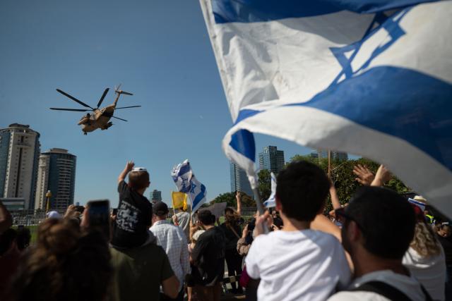 (251013) -- PETAH TIKVA, Oct. 13, 2025 (Xinhua) -- People celebrate as the helicopter carrying released hostages arrives at a hospital in Petah Tikva, Israel, Oct. 13, 2025. The Israeli military announced on Monday that all remaining living hostages held by Hamas in Gaza are now in Israel, as the country began releasing Palestinian prisoners.
   The military said in a statement that the final group of 13 hostages had crossed the border into Israeli territory. Earlier in the day, the first group of seven hostages returned to Israel after over two years of captivity in the Gaza Strip. (Xinhua/Chen Junqing)