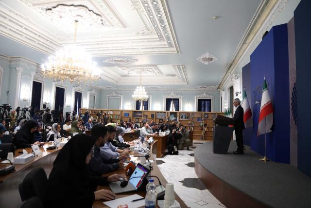 (251013) -- TEHRAN, Oct. 13, 2025 (Xinhua) -- Iranian Foreign Ministry Spokesman Esmaeil Baghaei (R) attends a press conference in Tehran, Iran, on Oct. 13, 2025. Iranian Foreign Ministry spokesman Esmaeil Baghaei said on Monday the recent claim by France, Germany and Britain, collectively known as the E3, about their determination to reinitiate nuclear negotiations with Iran lacks "goodwill and sincerity." (Xinhua/Shadati)