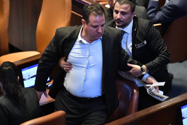 (251013) -- JERUSALEM, Oct. 13, 2025 (Xinhua) -- An Israeli Knesset member is taken away by security after displaying a sign calling for the recognition of Palestine during Trump's speech in Israeli parliament, the Knesset, in Jerusalem on Oct. 13, 2025. U.S. President Donald Trump addressed the Israeli parliament, the Knesset, on Monday during a brief visit as the Israel-Hamas ceasefire entered its fourth day, hailing an "end" to Israel's two-year war in Gaza. Trump's speech was briefly interrupted when a Knesset member displayed a sign calling for the recognition of Palestine. (JINI via Xinhua)