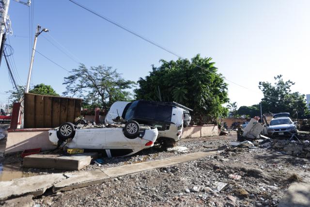 (251013) -- POZA RICA(MEXICO), Oct. 13, 2025 (Xinhua) -- Vehicles damaged by flood are seen on the street in Poza Rica city, Veracruz state, Mexico, Oct. 12, 2025. At least 64 people have died and dozens remain missing after days of torrential rains and flooding that hit central and eastern Mexico last week, authorities said Monday. (Photo by Francisco Canedo/Xinhua)