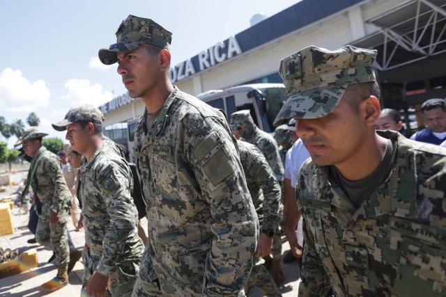 (251013) -- POZA RICA(MEXICO), Oct. 13, 2025 (Xinhua) -- Mexican soldiers prepare to help people affected by the heavy rain in the city of Poza Rica, Veracruz state, Mexico, Oct. 12, 2025. At least 64 people have died and dozens remain missing after days of torrential rains and flooding that hit central and eastern Mexico last week, authorities said Monday. (Photo by Francisco Canedo/Xinhua)