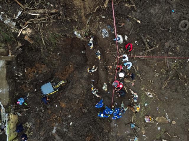 (251013) -- HUAUCHINANGO(MEXICO), Oct. 13, 2025 (Xinhua) -- This aerial drone photo taken on Oct. 13, 2025 shows rescue workers conducting a search in a landslide caused by the heavy rain in Huauchinango, Puebla state, Mexico. At least 64 people have died and dozens remain missing after days of torrential rains and flooding that hit central and eastern Mexico last week, authorities said Monday. (Photo by Francisco Canedo/Xinhua)
