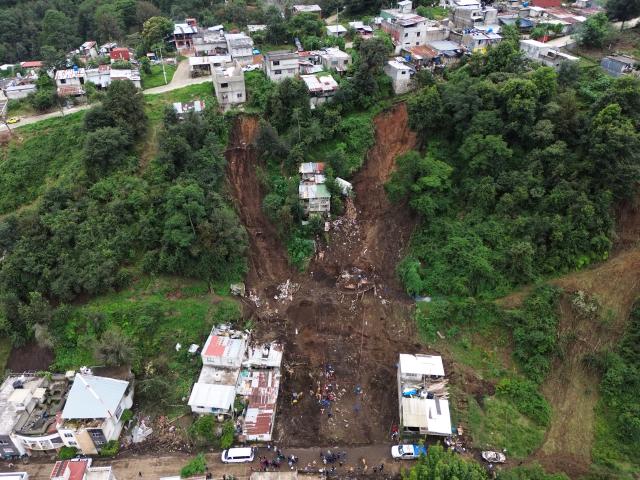 (251013) -- HUAUCHINANGO(MEXICO), Oct. 13, 2025 (Xinhua) -- This drone photo taken on Oct. 13, 2025 shows the aftermath after a landslide caused by the heavy rain in Huauchinango, Puebla state, Mexico. At least 64 people have died and dozens remain missing after days of torrential rains and flooding that hit central and eastern Mexico last week, authorities said Monday. (Photo by Francisco Canedo/Xinhua)