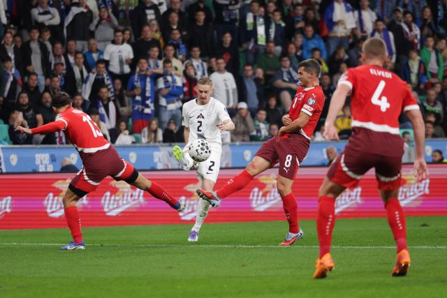 (251014) -- LJUBLJANA, Oct. 14, 2025 (Xinhua) -- Zan Karnicnik (2nd L) of Slovenia competes during the World Cup 2026 European Qualifiers Group B football match between Slovenia and Switzerland in Ljubljana, Slovenia, Oct. 13, 2025. (Photo by Zeljko Stevanic/Xinhua)