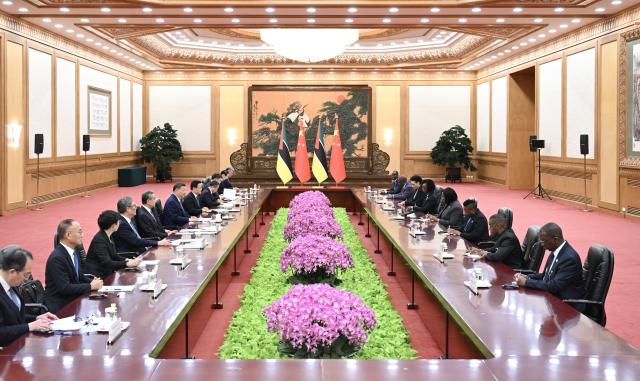 (251014) -- BEIJING, Oct. 14, 2025 (Xinhua) -- Chinese President Xi Jinping meets with Prime Minister of Mozambique Maria Benvinda Delfina Levi, who is in Beijing for the Global Leaders' Meeting on Women, at the Great Hall of the People in Beijing, capital of China, Oct. 14, 2025. (Xinhua/Xie Huanchi)