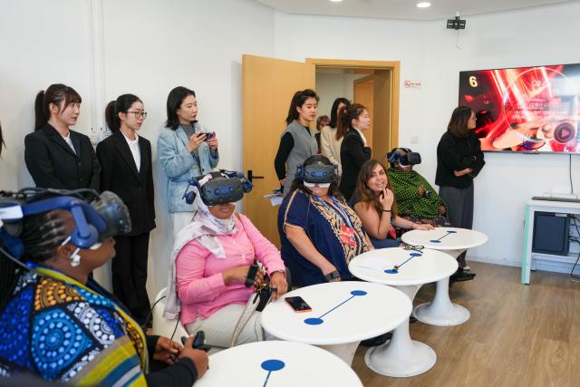 (251014) -- BEIJING, Oct. 14, 2025 (Xinhua) -- Representatives, who are in Beijing for the Global Leaders' Meeting on Women, try VR devices at a social service center for women and children in Shunyi District in Beijing, capital of China, Oct. 14, 2025. (Xinhua/Yan Linyun)
