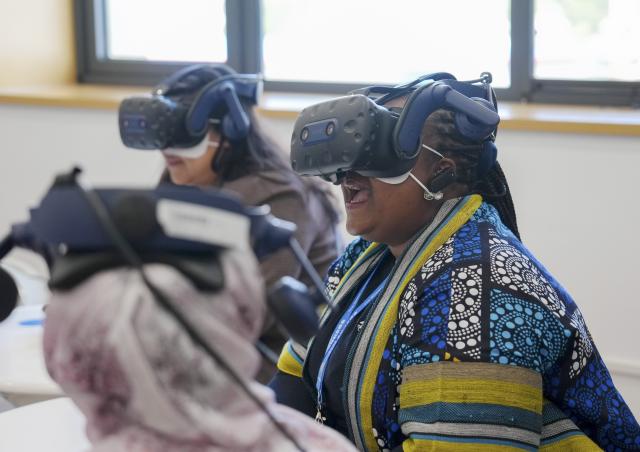 (251014) -- BEIJING, Oct. 14, 2025 (Xinhua) -- Representatives, who are in Beijing for the Global Leaders' Meeting on Women, try VR devices at a social service center for women and children in Shunyi District in Beijing, capital of China, Oct. 14, 2025. (Xinhua/Yan Linyun)