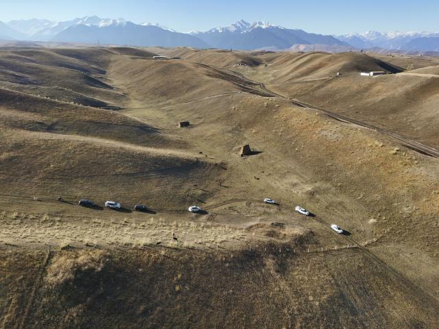(251014) -- TEKES, Oct. 14, 2025 (Xinhua) -- An aerial drone photo shows a vehicle procession heading to the home of the groom Bukehan Yelszi in Karadala Township of Tekes County, northwest China's Xinjiang Uygur Autonomous Region, Oct. 11, 2025.
  A blue sky, white clouds, vast grassland, horses and automobiles set a poetic and picturesque wedding scene for the newlyweds Kumusi Yesdawulti and Bukehan Yelszi. 
  For the couple, having fallen in love a year ago, a traditional wedding ceremony was at the top of their to-do list.
  Without a hair out of place, Kumusi, dressed head to toe in traditional costume and adorned in a red veil, married her better half Bukehan, describing the wedding as a dream realized.
  Throughout the wedding festivities, the couple's loved ones congregated to join in the celebration. Some of them played traditional musical instruments, such as dombra, and performed inspiring festive dances, while others lent their hands to prepare local specialties, including naan bread and baursak.
  A modern outdoor wedding ensued at dusk in a forest park, where the couple shared champagne and danced with their relatives and friends. The event's long-lasting atmosphere of joy, harmony and warmth drew locals and tourists to immerse themselves in joy and happiness together.
  "With horses and automobiles, the wedding is really special and lively," said Kumusi. (Xinhua/Hu Huhu)