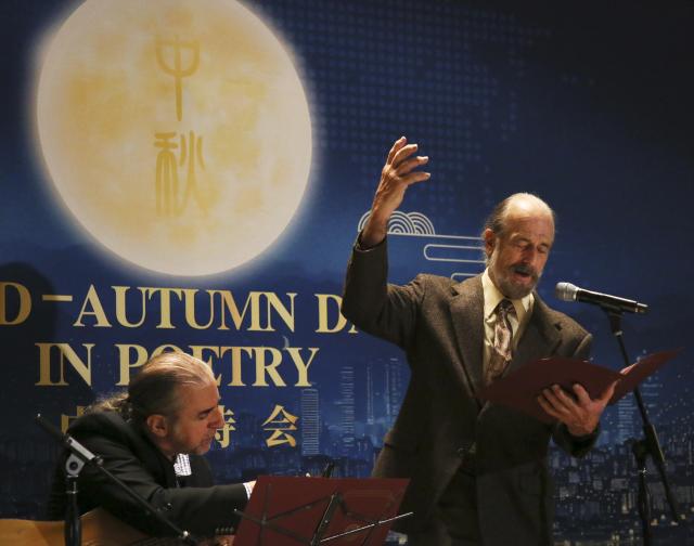 (251014) -- UNITED NATIONS, Oct. 14, 2025 (Xinhua) -- Poet Kirk Larsen reads a poem at the UN headquarters in New York, Oct. 13, 2025. The 2025 "Mid-Autumn Day in Poetry" celebration lit up the United Nations (UN) Headquarters with the spirit of reunion, harmony and cultural exchange on Monday night. (Xinhua/Zhang Fengguo)