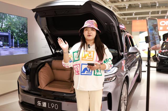 (251014) -- BEIJING, Oct. 14, 2025 (Xinhua) -- A salesperson introduces performance of a new energy vehicle to customers via live-streaming at a shopping mall in Wuchang District of Wuhan City, central China's Hubei Province, on Oct. 14, 2025. China's new energy vehicle (NEV) sector maintained strong momentum in production and sales in the first nine months of the year, according to industry data released Tuesday.
   NEV production jumped 35.2 percent year on year to 11.24 million units during the first three quarters, as reported by China Association of Automobile Manufacturers (CAAM).
   Sales during the same period climbed 34.9 percent year on year to nearly 11.23 million units, accounting for 46.1 percent of total vehicle sales in China, CAAM data showed. (Photo by Zhao Jun/Xinhua)