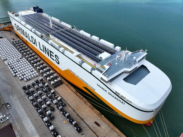 (251014) -- BEIJING, Oct. 14, 2025 (Xinhua) -- An aerial drone photo taken on Oct. 14, 2025 shows cars ready for transportation parking besides a roll-on/roll-off (RORO) ship at a wharf in Lianyungang, east China's Jiangsu Province. China's new energy vehicle (NEV) sector maintained strong momentum in production and sales in the first nine months of the year, according to industry data released Tuesday.
   NEV production jumped 35.2 percent year on year to 11.24 million units during the first three quarters, as reported by China Association of Automobile Manufacturers (CAAM).
   Sales during the same period climbed 34.9 percent year on year to nearly 11.23 million units, accounting for 46.1 percent of total vehicle sales in China, CAAM data showed. (Photo by Wang Chun/Xinhua)