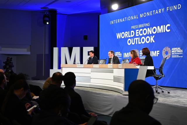 (251014) -- WASHINGTON, Oct. 14, 2025 (Xinhua) -- The International Monetary Fund (IMF) chief economist Pierre-Olivier Gourinchas (2nd L) speaks at a press briefing on World Economic Outlook in Washington, D.C., the United States, Oct. 14, 2025. IMF on Tuesday raised its global economic growth for 2025 to 3.2 percent, 0.2 percentage point higher than the July forecast, the latest World Economic Outlook report said. (Xinhua/Li Rui)