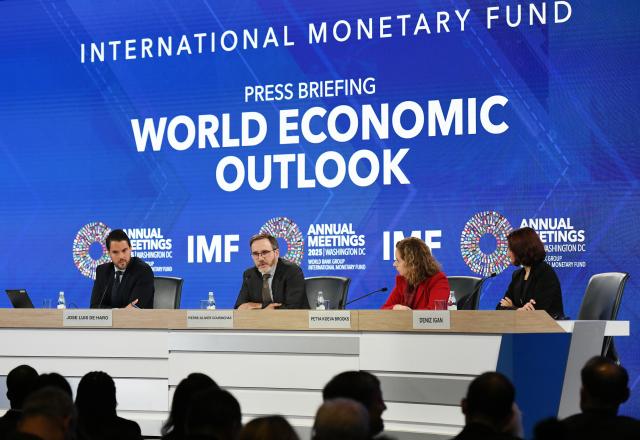 (251014) -- WASHINGTON, Oct. 14, 2025 (Xinhua) -- The International Monetary Fund (IMF) chief economist Pierre-Olivier Gourinchas (2nd L) speaks at a press briefing on World Economic Outlook in Washington, D.C., the United States, Oct. 14, 2025. IMF on Tuesday raised its global economic growth for 2025 to 3.2 percent, 0.2 percentage point higher than the July forecast, the latest World Economic Outlook report said. (Xinhua/Li Rui)