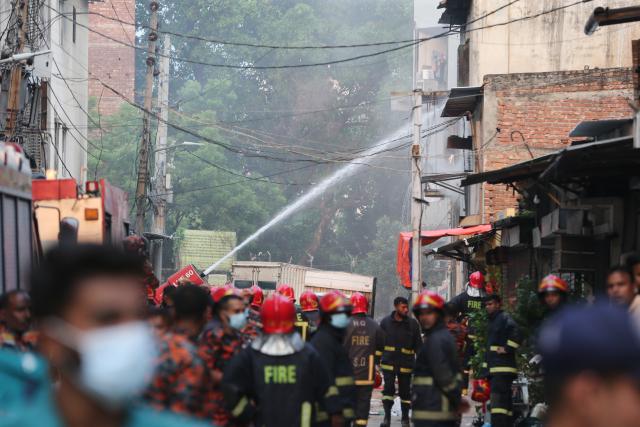 (251014) -- DHAKA, Oct. 14, 2025 (Xinhua) -- Photo taken on Oct. 14, 2025 shows firefighters working to put out the fire at a garment factory and a chemical warehouse in Dhaka, Bangladesh. At least 16 people were killed after a devastating fire tore through a garment factory and a chemical warehouse in the Bangladeshi capital of Dhaka. (Photo by Habibur Rahman/Xinhua)