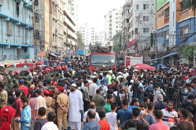 (251014) -- DHAKA, Oct. 14, 2025 (Xinhua) -- This photo taken on Oct. 14, 2025 shows people gathering at the scene after fire broke out at a garment factory and a chemical warehouse in Dhaka, Bangladesh. At least 16 people were killed after a devastating fire tore through a garment factory and a chemical warehouse in the Bangladeshi capital of Dhaka. (Photo by Habibur Rahman/Xinhua)