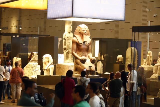 (251014) -- CAIRO, Oct. 14, 2025 (Xinhua) -- Tourists view exhibits at the Grand Egyptian Museum in Giza, Egypt, Oct. 14, 2025. Egypt's Grand Egyptian Museum (GEM) is temporarily closed to the public from Oct. 15 to Nov. 3 in preparation for its official opening, scheduled for early November, according to an announcement published Monday on the museum's official website. (Xinhua/Ahmed Gomaa)