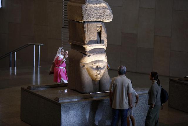 (251014) -- CAIRO, Oct. 14, 2025 (Xinhua) -- Tourists view an exhibit at the Grand Egyptian Museum in Giza, Egypt, Oct. 14, 2025. Egypt's Grand Egyptian Museum (GEM) is temporarily closed to the public from Oct. 15 to Nov. 3 in preparation for its official opening, scheduled for early November, according to an announcement published Monday on the museum's official website. (Xinhua/Ahmed Gomaa)