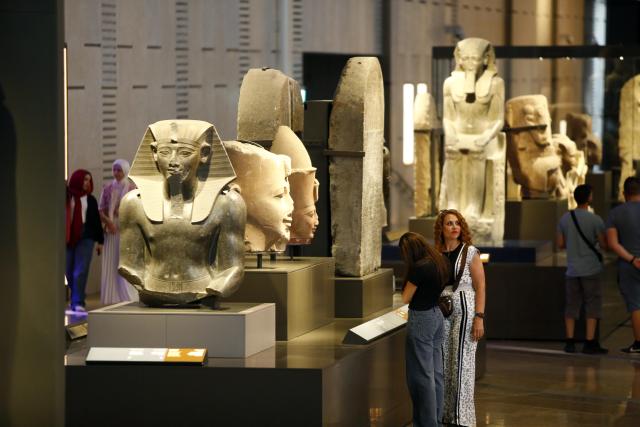 (251014) -- CAIRO, Oct. 14, 2025 (Xinhua) -- Tourists view exhibits at the Grand Egyptian Museum in Giza, Egypt, Oct. 14, 2025. Egypt's Grand Egyptian Museum (GEM) is temporarily closed to the public from Oct. 15 to Nov. 3 in preparation for its official opening, scheduled for early November, according to an announcement published Monday on the museum's official website. (Xinhua/Ahmed Gomaa)