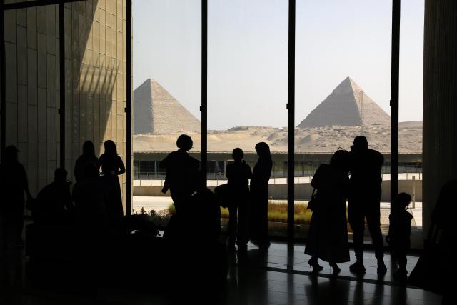 (251014) -- CAIRO, Oct. 14, 2025 (Xinhua) -- Tourists view the Giza Pyramids while visiting the Grand Egyptian Museum in Giza, Egypt, Oct. 14, 2025. Egypt's Grand Egyptian Museum (GEM) is temporarily closed to the public from Oct. 15 to Nov. 3 in preparation for its official opening, scheduled for early November, according to an announcement published Monday on the museum's official website. (Xinhua/Ahmed Gomaa)