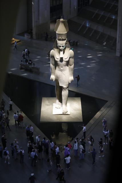 (251014) -- CAIRO, Oct. 14, 2025 (Xinhua) -- Tourists stand around the colossus of ancient Egyptian pharaoh Ramses II at the Grand Egyptian Museum in Giza, Egypt, Oct. 14, 2025. Egypt's Grand Egyptian Museum (GEM) is temporarily closed to the public from Oct. 15 to Nov. 3 in preparation for its official opening, scheduled for early November, according to an announcement published Monday on the museum's official website. (Xinhua/Ahmed Gomaa)
