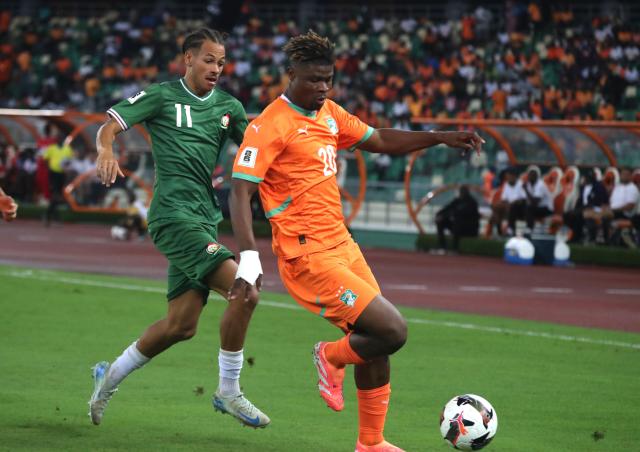 (251015) -- ABIDJAN, Oct. 15, 2025 (Xinhua) -- Emmanuel Agbadou (R) of Cote d'Ivoire vies for the ball during the FIFA World Cup 2026 CAF Qualifiers Group F match between Cote d'Ivoire and Kenya in Abidjan, Cote d'Ivoire, Oct. 14, 2025. (Photo by Yvan Sonh/Xinhua)