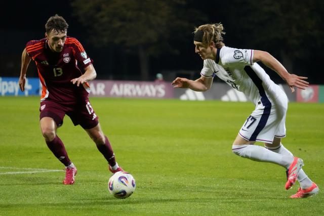 (251015) -- RIGA, Oct. 15, 2025 (Xinhua) -- Raivis Jurkovskis (L) of Latvia vies with Anthony Gordon of England during the 2026 FIFA World Cup European Qualifiers football match between Latvia and England in Riga, Latvia, Oct. 14, 2025. (Photo by Edijs Palens/Xinhua)