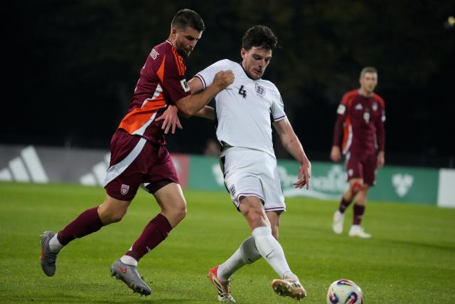 (251015) -- RIGA, Oct. 15, 2025 (Xinhua) -- Antonijs Cernomordijs (L) of Latvia vies with Declan Rice of England during the 2026 FIFA World Cup European Qualifiers football match between Latvia and England in Riga, Latvia, Oct. 14, 2025. (Photo by Edijs Palens/Xinhua)