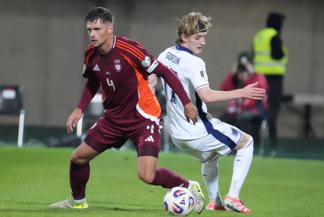 (251015) -- RIGA, Oct. 15, 2025 (Xinhua) -- Roberts Veips (L) of Latvia vies with Anthony Gordon of England during the 2026 FIFA World Cup European Qualifiers football match between Latvia and England in Riga, Latvia, Oct. 14, 2025. (Photo by Edijs Palens/Xinhua)