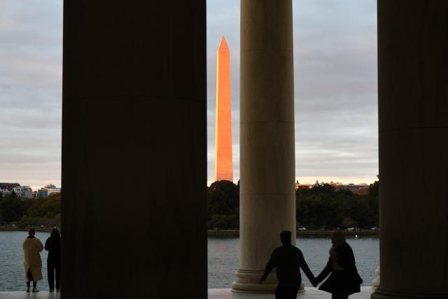 (251015) -- WASHINGTON, Oct. 15, 2025 (Xinhua) -- This photo taken on Oct. 14, 2025 shows the Washington Monument at sunset seen through the Thomas Jefferson Memorial in Washington, D.C., the United States. As the U.S. federal government shutdown stretches into its third week, Treasury Secretary Scott Bessent warned that the closure is already beginning to weigh on the real economy. (Xinhua/Li Rui)