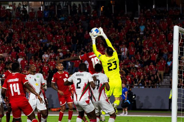 (251015) -- PANAMA CITY, Oct. 15, 2025 (Xinhua) -- Suriname's goalkeeper Etienne Vaessen (1st R) makes a save during the 2026 FIFA World Cup Concacaf qualifier football match between Panama and Suriname in Panama City, Panama, on Oct. 14, 2025. (Xinhua/Xu Yongzheng)