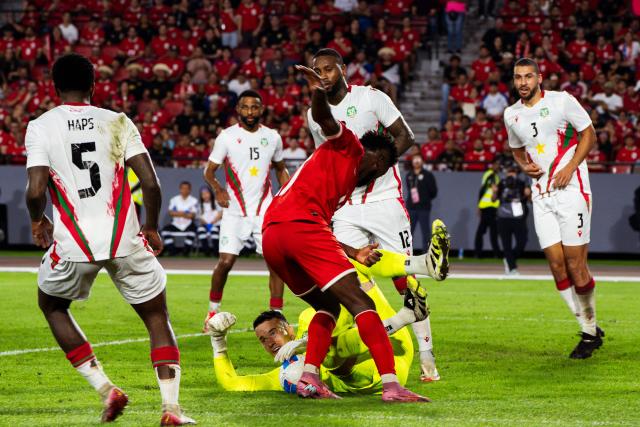 (251015) -- PANAMA CITY, Oct. 15, 2025 (Xinhua) -- Suriname's goalkeeper Etienne Vaessen (bottom) makes a save during the 2026 FIFA World Cup Concacaf qualifier football match between Panama and Suriname in Panama City, Panama, on Oct. 14, 2025. (Xinhua/Xu Yongzheng)