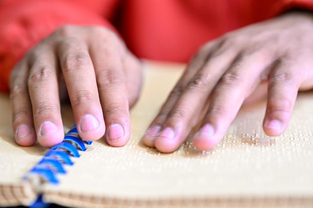 (251015) -- LHASA, Oct. 15, 2025 (Xinhua) -- Tawa Tsering reads a braille book in Lhasa, southwest China's Xizang Autonomous Region, Oct. 10, 2025. Twenty-six-year-old Tawa Tsering is a musician of band "Kardag Garbo," the first band in Xizang composed of visually impaired members. The band was established in 2014 and its name means pure white Khata, a ceremonial white scarf symbolizing goodwill and blessings. 
   In 2019, Tawa Tsering joined the band and began to learn playing flute and Yangqin. In addition to performing, he handles the band's daily affairs, such as arranging performances, exploring business collaborations, and booking performance venues.
   Music opened a vast world for Tawa Tsering and also led him to love. He married Bumchok, sister of the band's founder, and is now father of two children.
   "If life is entirely wasted just because of a physical disability, it would be the greatest regret," this is the shared belief of the members of the band. Every summer, they tour villages and towns to stage performances. "We hold performances every year to encourage people like us through concrete actions," said Tawa Tsering. (Xinhua/Zhang Cheng)