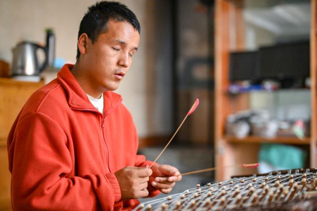 (251015) -- LHASA, Oct. 15, 2025 (Xinhua) -- Tawa Tsering plays Yangqin in Lhasa, southwest China's Xizang Autonomous Region, Oct. 11, 2025. Twenty-six-year-old Tawa Tsering is a musician of band "Kardag Garbo," the first band in Xizang composed of visually impaired members. The band was established in 2014 and its name means pure white Khata, a ceremonial white scarf symbolizing goodwill and blessings. 
   In 2019, Tawa Tsering joined the band and began to learn playing flute and Yangqin. In addition to performing, he handles the band's daily affairs, such as arranging performances, exploring business collaborations, and booking performance venues.
   Music opened a vast world for Tawa Tsering and also led him to love. He married Bumchok, sister of the band's founder, and is now father of two children.
   "If life is entirely wasted just because of a physical disability, it would be the greatest regret," this is the shared belief of the members of the band. Every summer, they tour villages and towns to stage performances. "We hold performances every year to encourage people like us through concrete actions," said Tawa Tsering. (Xinhua/Zhang Cheng)