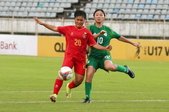 (251015) -- YANGON, Oct. 15, 2025 (Xinhua) -- Khaing Zin Myint (L) of Myanmar vies with Lok Sam Io of China's Macao during the AFC U17 Women's Asian Cup China 2026 qualifier between Myanmar and China's Macao in Yangon, Myanmar, Oct. 15, 2025. (Xinhua/Myo Kyaw Soe)