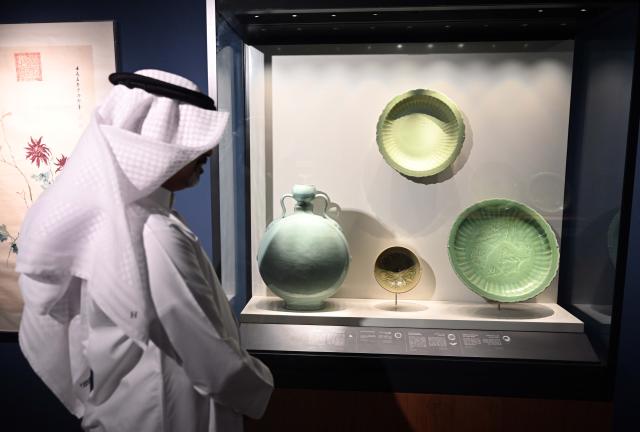(251015) -- KUWAIT CITY, Oct. 15, 2025 (Xinhua) -- A man visits the exhibition in Kuwait City, Kuwait, Oct. 15, 2025. The Chinese art exhibition "Distant and Close" opened on Wednesday at Kuwait's Dar al-Athar al-Islamiyyah, or House of Islamic Antiquities, a major public museum in Kuwait City. The exhibition, running through 2026, showcases the historical and cultural ties between China and Kuwait. (Photo by Asad/Xinhua)