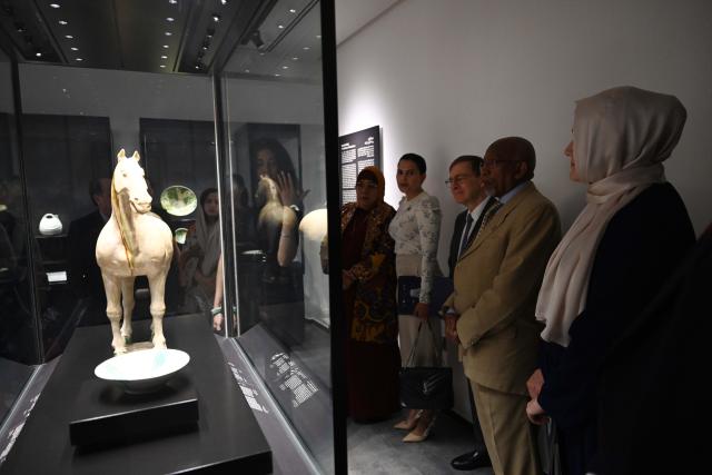 (251015) -- KUWAIT CITY, Oct. 15, 2025 (Xinhua) -- People visit the exhibition in Kuwait City, Kuwait, Oct. 15, 2025. The Chinese art exhibition "Distant and Close" opened on Wednesday at Kuwait's Dar al-Athar al-Islamiyyah, or House of Islamic Antiquities, a major public museum in Kuwait City. The exhibition, running through 2026, showcases the historical and cultural ties between China and Kuwait. (Photo by Asad/Xinhua)