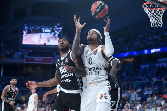 (251016) -- MADRID, Oct. 16, 2025 (Xinhua) -- Chuma Okeke (R) of Real Madrid vies with Tyrique Jones of Partizan during the Euroleague basketball match between Real Madrid and Partizan in Madrid, Spain, Oct. 15, 2025. (Photo by Gustavo Valiente/Xinhua)