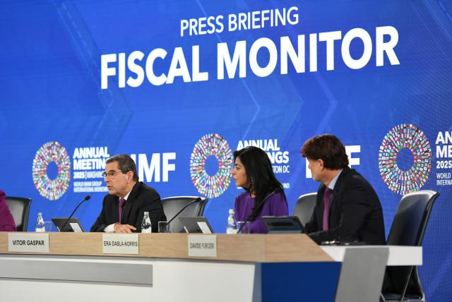 (251016) -- WASHINGTON, Oct. 16, 2025 (Xinhua) -- Vitor Gaspar (L), outgoing director of the IMF's fiscal affairs department, speaks at a press briefing on Fiscal Monitor in Washington, D.C., the United States. In the latest Fiscal Monitor released Wednesday, the IMF argued that enhancing spending efficiency can magnify gains "substantially," and alleviate the fiscal policy trilemma. (Xinhua/Li Rui)