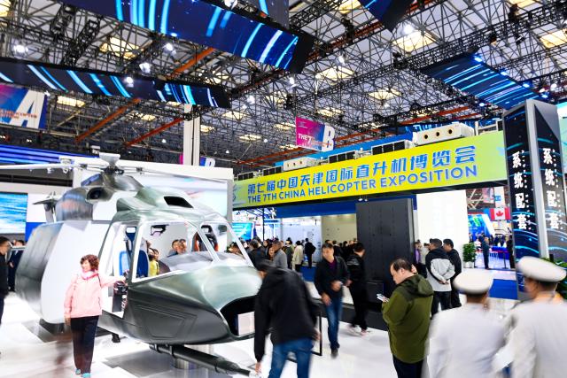 (251016) -- TIANJIN, Oct. 16, 2025 (Xinhua) -- People visit the 7th China Helicopter Exposition in Tianjin, north China, Oct. 16, 2025. Spanning an exhibition area of approximately 160,000 square meters, the exposition kicked off here on Thursday and will last until Oct. 19. (Xinhua/Zhao Zishuo)