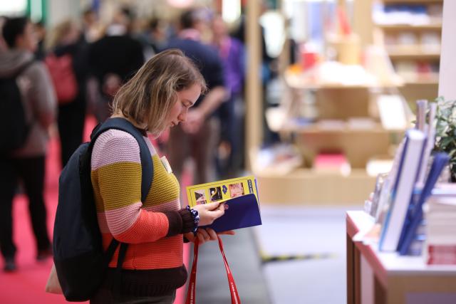 (251016) -- FRANKFURT, Oct. 16, 2025 (Xinhua) -- A woman visits the Frankfurt Book Fair in Frankfurt, Germany, Oct. 16, 2025. The world's largest book fair, the Frankfurt Book Fair, opened here on Tuesday with a focus on licensing and rights exchange.
   More than 4,000 publishers from over 90 countries and regions are present at the 77th book fair and more than 200,000 visitors are expected, said Juergen Boos, director of the Fair, at the opening ceremony.
   Chinese publishers are making a strong presence at the book fair, showcasing more than 5,000 titles and 6,500 copies, with foreign-language editions accounting for over one-third of the total. (Xinhua/Du Zheyu)