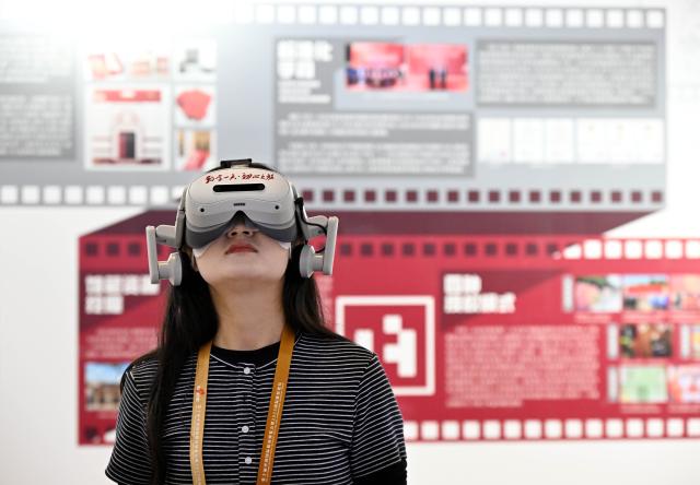 (251016) -- QINGDAO, Oct. 16, 2025 (Xinhua) -- An attendee tries a VR device at the tenth China International Copyright Expo in Qingdao, east China's Shandong Province, Oct. 16, 2025. Themed "Digital Intelligence Leads the Future, Copyright Promotes Innovative Development," the tenth China International Copyright Expo and 2025 International Copyright Forum opened Thursday in Qingdao. (Xinhua/Li Ziheng)