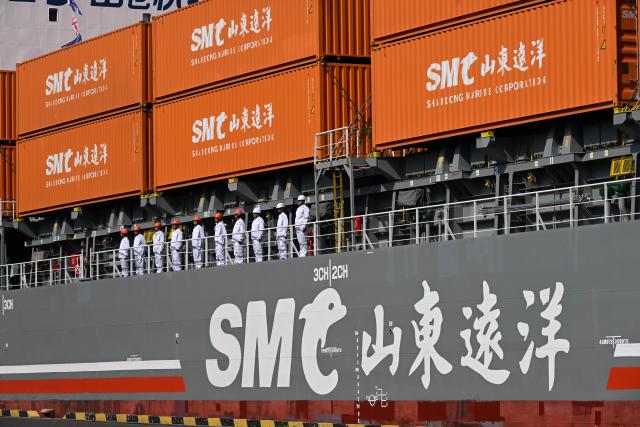 (251016) -- QINGDAO, Oct. 16, 2025 (Xinhua) -- Crew members of the "SMC RIZHAO" ship performing the maiden voyage of the Qingdao-Jeju container shipping route line up on the deck at the Qingdao International Cruise Terminal in Qingdao, east China's Shandong Province, on Oct. 16, 2025. A regular direct container shipping route between Qingdao and South Korea's Jeju was launched on Thursday. This express shipping route will operate once a week in its initial stage, significantly enhancing the logistics efficiency between the two places, effectively reducing logistics costs, and further densifying the shipping network of east China's Shandong Province to South Korea. (Xinhua/Li Ziheng)