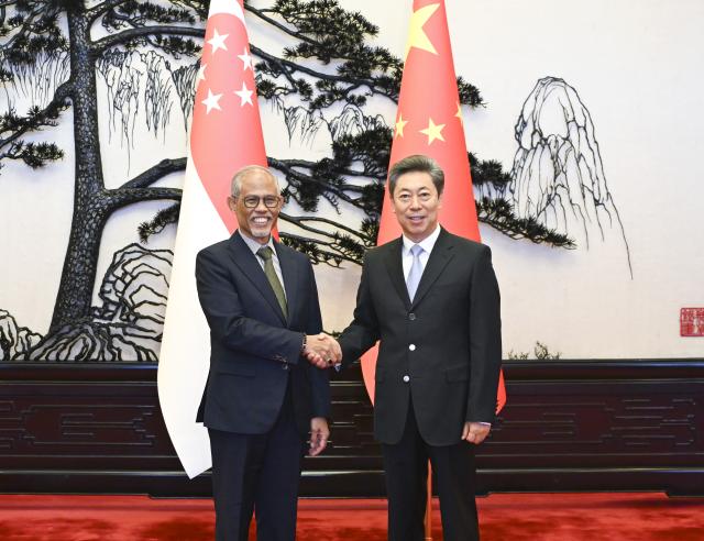 (251016) -- BEIJING, Oct. 16, 2025 (Xinhua) -- Chen Wenqing, a member of the Political Bureau of the Communist Party of China (CPC) Central Committee and head of the Commission for Political and Legal Affairs of the CPC Central Committee, meets with Singaporean Minister for Social and Family Development Masagos Zulkifli in Beijing, capital of China, Oct. 15, 2025. (Xinhua/Yan Yan)